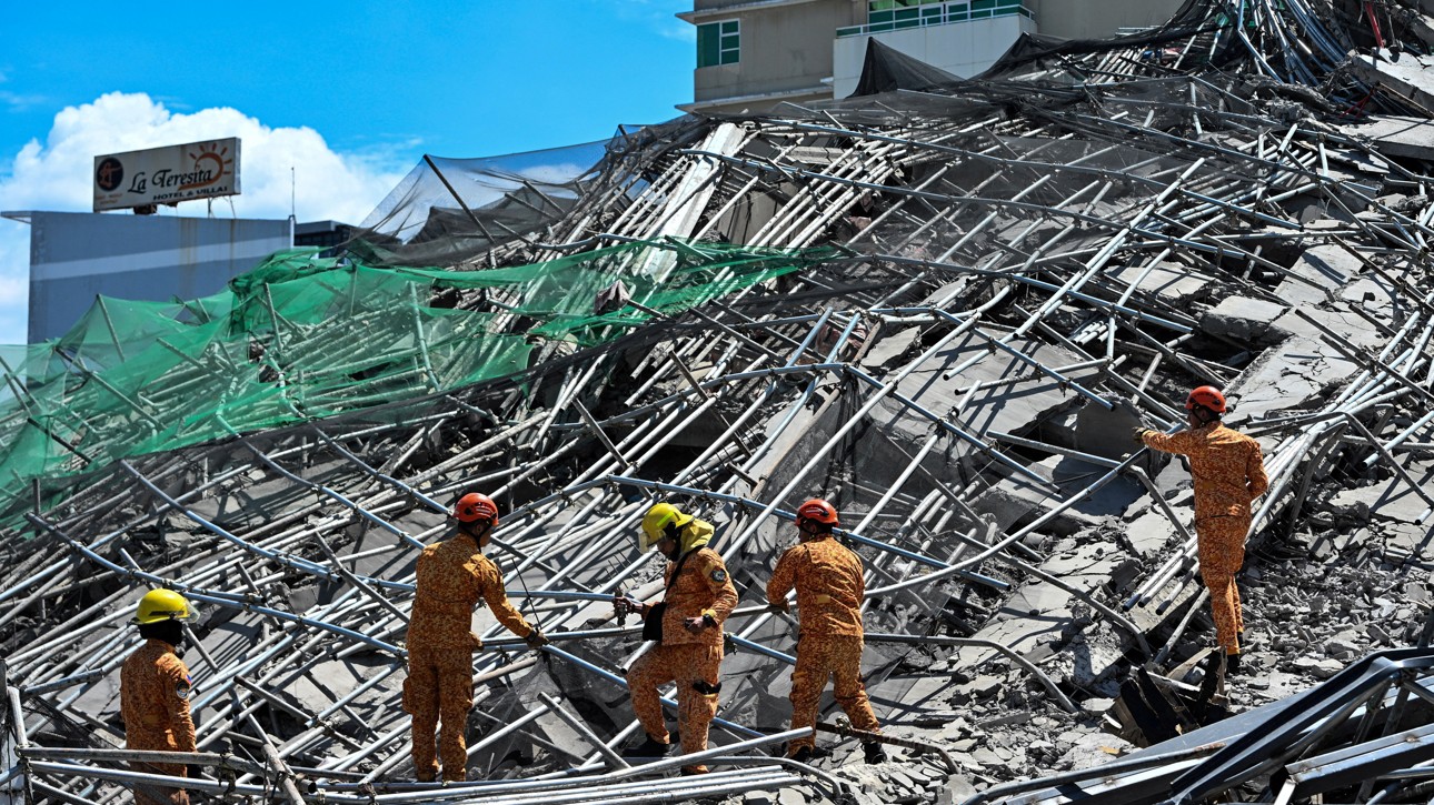 Rescuers at the site of a collapsed building in Angeles City