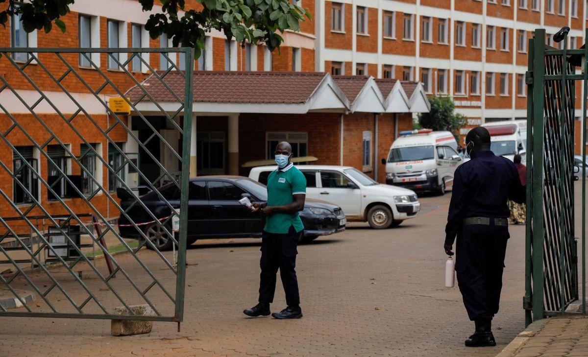 Workers stand guard at the gate of the Kibuli Muslim Hospital where a Congolese man died of Ebola Bundibugyo virus in Kibuli suburb of Kampala, Uganda