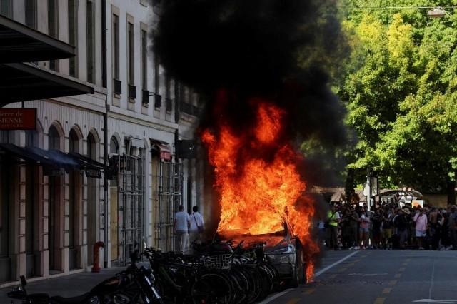 A Tesla car burns during a protest against the upcoming G7 summit in Evian-les-Bains in France, in Geneva, Switzerland, June 14, 2026. REUTERS/ Umit Bektas