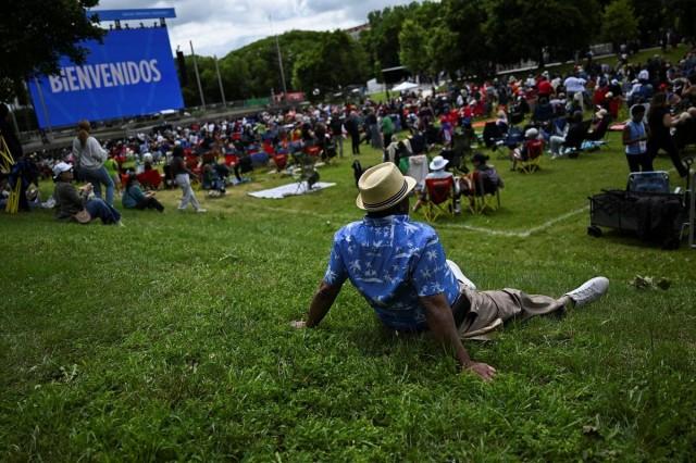 A man sits on the grass at a watch party at the Midway Plaisance Park. REUTERS/ Joshua Lott