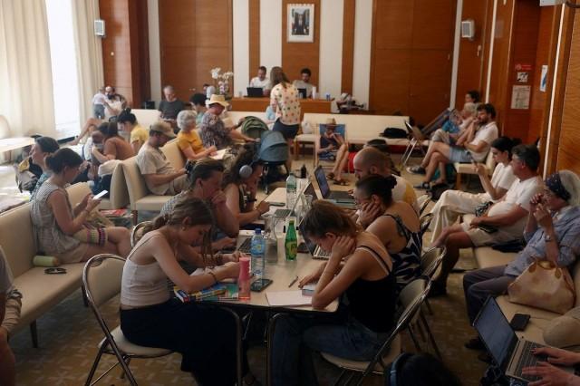 People gather in a air-conditioned room open to the public inside the 17th district city hall as temperatures rise in Paris, during a heatwave affecting a majority of the country, in France, June 25, 2026. REUTERS/ Alice Sacco