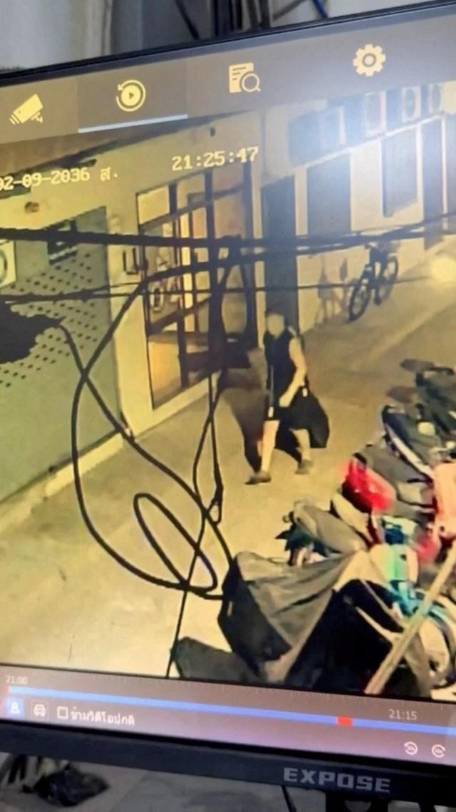Simon Peter Carman walks with a suitcase outside a condominium, in Pattaya City, Thailand, in this screengrab obtained from a handout video released on June 27, 2026. Pattaya Provincial Police Station/ Handout via REUTERS 