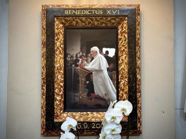 On the right side of the altar is a photo of Pope Benedict XVI kneeling before the image of the Infant Jesus at the Church of Our Lady Victorious in Prague. During his apostolic visit to the Czech Republic on September 26-28, 2009, the pope prayed to the Infant Jesus for children, including those who fall victim to abuse and violence. Photo: Andy Peñafuerte III