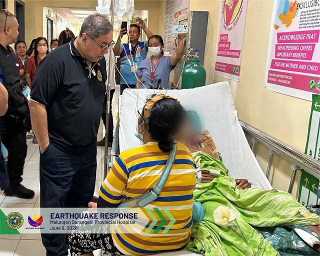 Health Secretary Ted Herbosa talks to a patient in a hallway of the Malungon Sarangani Provincial Hospital on June 9, 2026. In a Facebook post, the DOH said that the patients are gradually being allowed back in the hospital after the earthquake. Photo: Department of Health