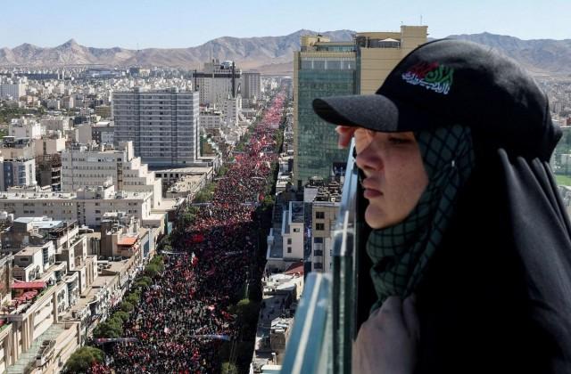 A woman looks on, as mourners gather on the day of the burial of Iran's Supreme Leader Ayatollah Ali Khamenei, who was killed on February 28 in Israeli and US airstrikes, in Mashhad, Iran, July 9, 2026. REUTERS/Mohammed Salem