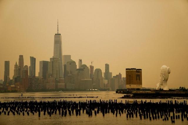 The New York City skyline and the One World Trade Center are seen through a cover of wildfire smoke as seen from Newport, New Jersey. The smoke, produced by wildfires in northwestern Ontario, has blackened skies and spread into the northeastern US, July 16, 2026. REUTERS/ Eduardo Mu&ntilde;oz