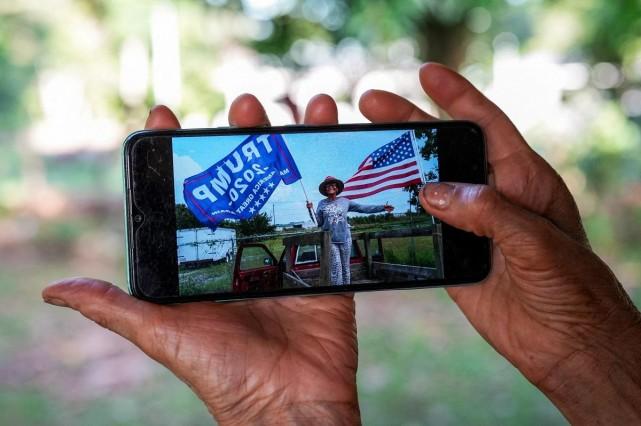 Dora Damatta-Rodriguez displays on her mobile phone a photograph of herself posing with a pro-Trump flag and a US flag, at her home in San Carlos, Panama, July 6, 2026. REUTERS/ Enea Lebrun
