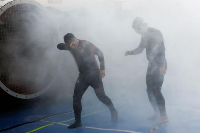 Participants walk through simulated typhoon-force wind and rain during a typhoon survival training session at the Lvxing Disaster Simulation Training Center in Hangzhou, Zhejiang province, China, July 15, 2026. REUTERS/Go Nakamura 