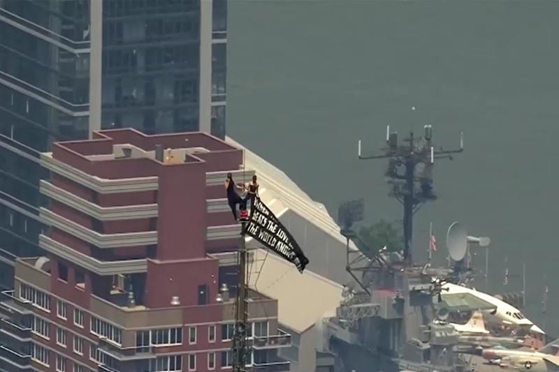 Two people unfurl peace banner atop NY's Empire State Building in apparent proposal stunt