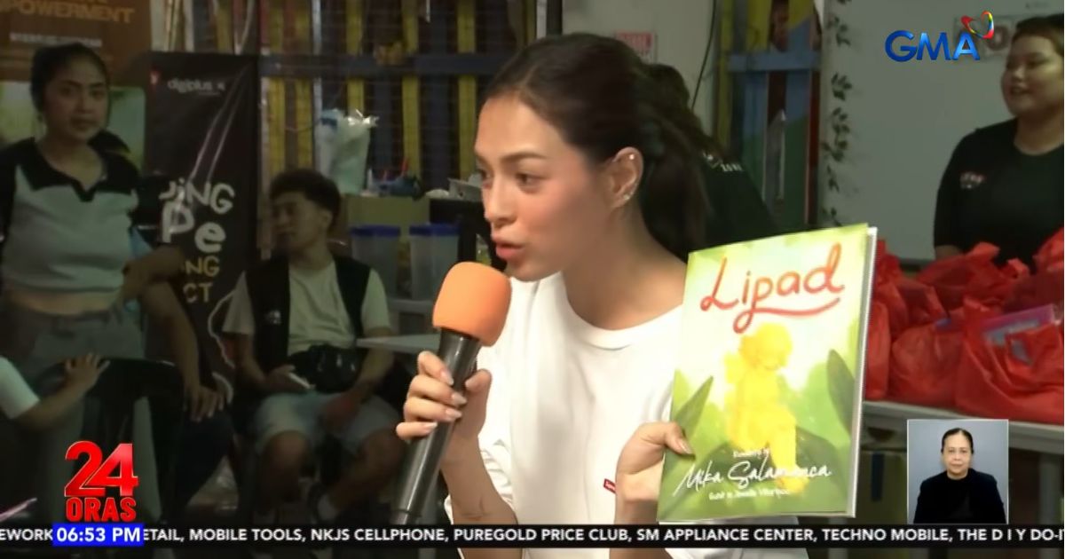 Mika Salamanca gives copies of her children's book at outreach in Manila