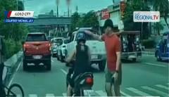 Lalaki, kinaltok sa helmet ang rider na nagtuloy-tuloy sa pagdaan sa pedestrian lane habang may tumatawid