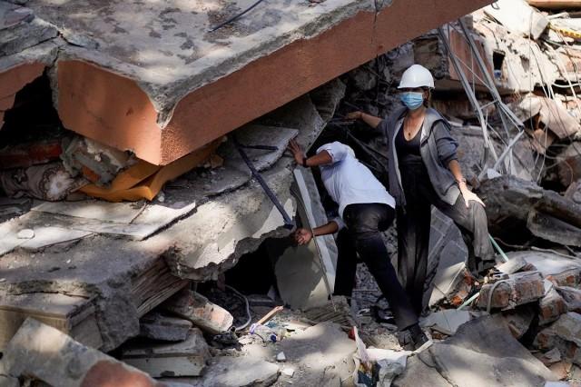 People search for survivors at the site of a collapsed building, in the aftermath of an earthquake, in Cali, Colombia, August 11, 2026. REUTERS/ Sergio Acero
