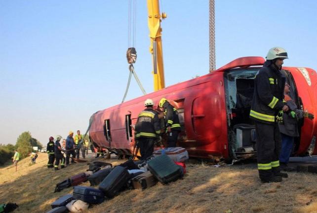 Firefighters work at the scene of a deadly accident, where a Polish bus carrying tourists veered off the motorway and overturned, near Mezokeresztes, Hungary, in this handout image released on August 16, 2026. Balazs Toth/ Mezokovesd Kepekben/ Handout via REUTERS