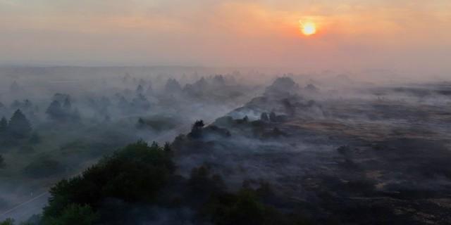 A drone view shows smoke rising from burnt fields and forests during a wildfire near Waimes, in the High Fens (Hautes Fagnes) region, Belgium August 16, 2026. REUTERS/Yves Herman