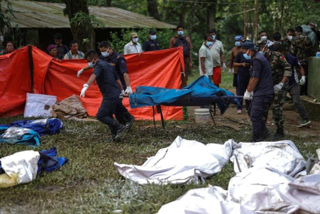 Members of Nepal army carry victims who were airlifted from an area affected by flash floods and a mudslide, at the Maithili Barrack, an army training center in Trishuli, Nuwakot district, Nepal, August 30, 2026. REUTERS/ Athit Perawongmetha