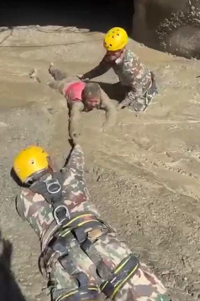 Nepali Army members rescue a person trapped inside a tunnel at a hydropower project following a flash flood in Rasuwa, Nepal, in this still image from handout video released August 28, 2026. PMO Nepal/ Handout via Agence France-Presse