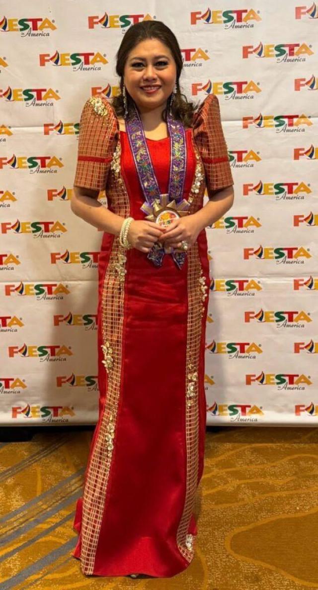 Ria Serrano is presented the first Intergenerational Impact Award. Courtesy: Anthony Bautista via The FilAm