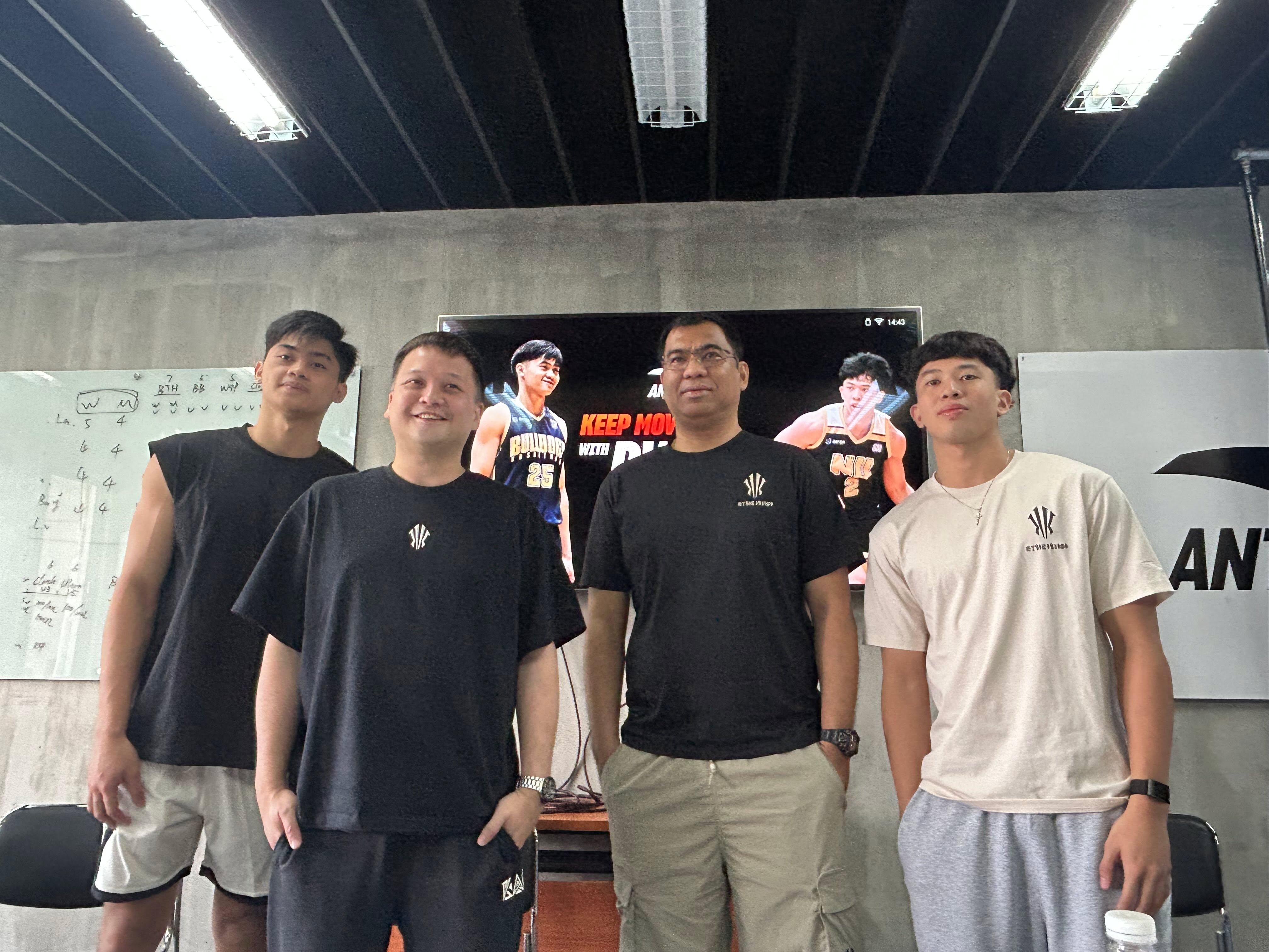 NU coach Jeff Napa with Bulldogs Vince Reyes and Dwyne Miranda