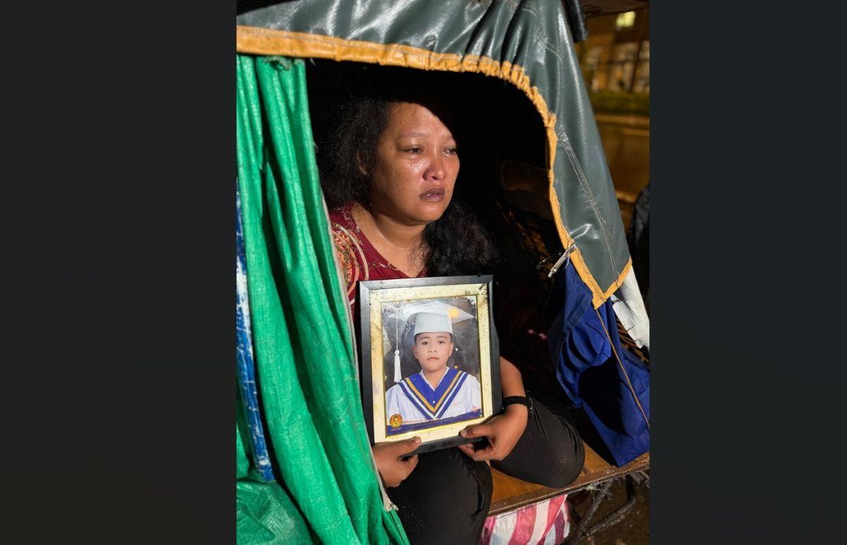 Mother with photo of 13-year-old son who went missing after swimming in Baseco Beach
