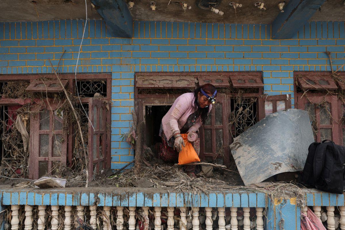 Residents try to save belongings from mud-filled houses in Nepal