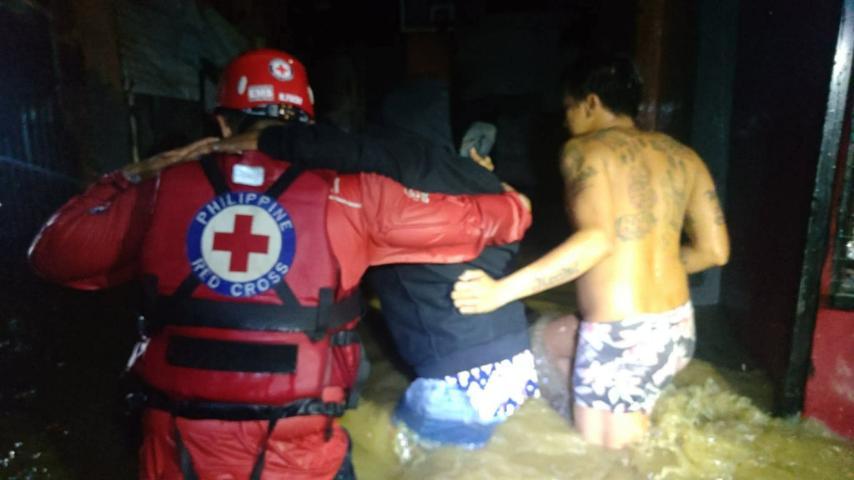 Philippine Red Cross personnel rescue residents in North Fairview, Quezon City
