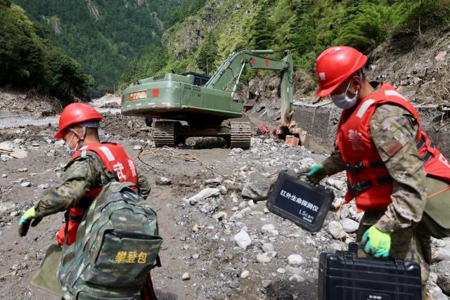 Chinese People's Armed Police officers carry out search and rescue operations near Gyirong port following a mudslide, in Shigatse, Tibet Autonomous Region, China August 30, 2026. China Daily via REUTERS