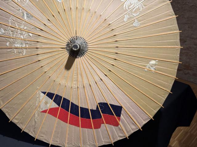 This Japanese parasol, made of white silk and decorated with embroidery of chrysanthemum, wisteria, and the then-Philippine flag, was a wedding gift from the Aguinaldo government to Loleng Blumentritt and Karl Pickert. Photo: Andy Peñafuerte III