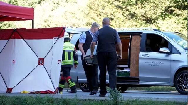 Men carry a coffin into a hears near the crashed bus, in Buchloe, Germany, an hour's drive from Munich, September 27, 2026. Reuters video