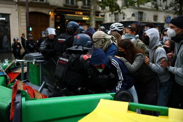 French riot gendarmes attempt to move protesters standing behind a barricade to block the Boulevard Saint-Germain outside Sciences Po university in Paris, October 7, 2026. REUTERS/ Sarah Meyssonnier