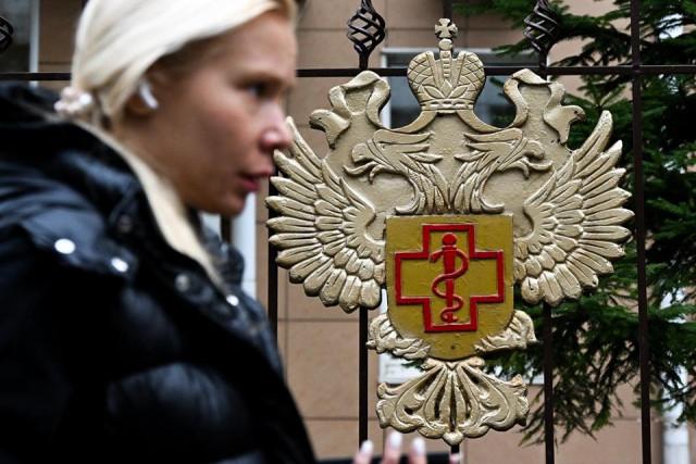 A woman walks past the logo of Russia's consumer and health watchdog Rospotrebnadzor in Moscow on October 5, 2026. Igor Ivanko/ AFP