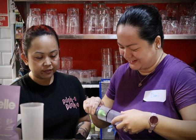 Valencia-based entrepreneurs Jerine Quemades (left) and Dani de Castro (right) team up for the Filipino food pop-up at the former's restaurant. De Castro offers guests ube latte as a welcome drink. Photo: Andy Peñafuerte III