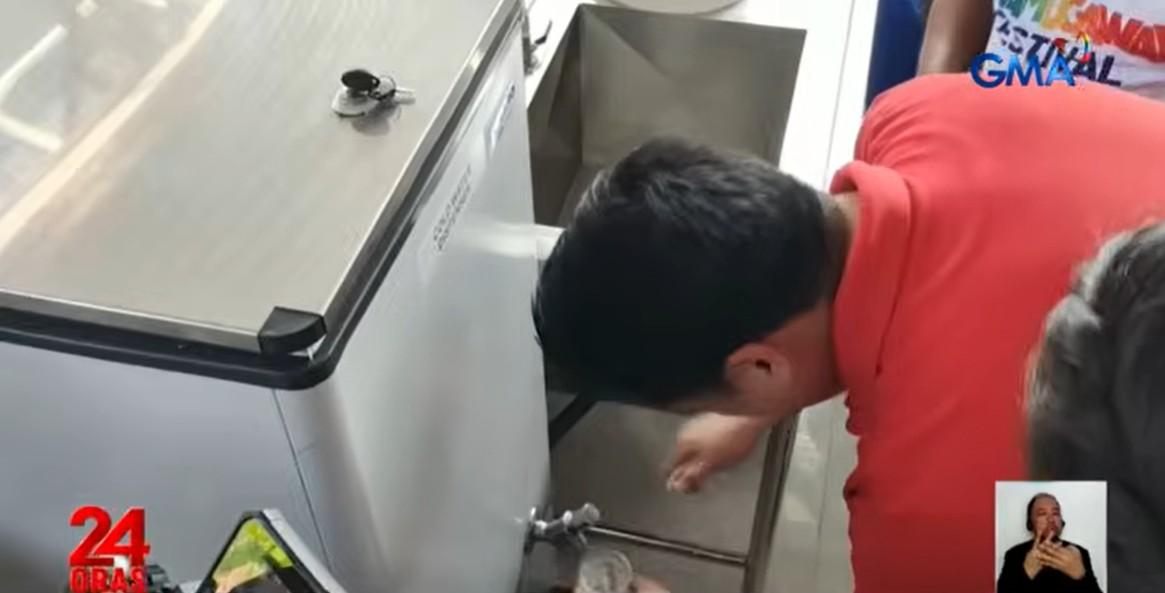 DSWD Sec. Rex Gatchalian getting drinking water produced by the air-to-water project of DSWD in Cawayan, Masbate