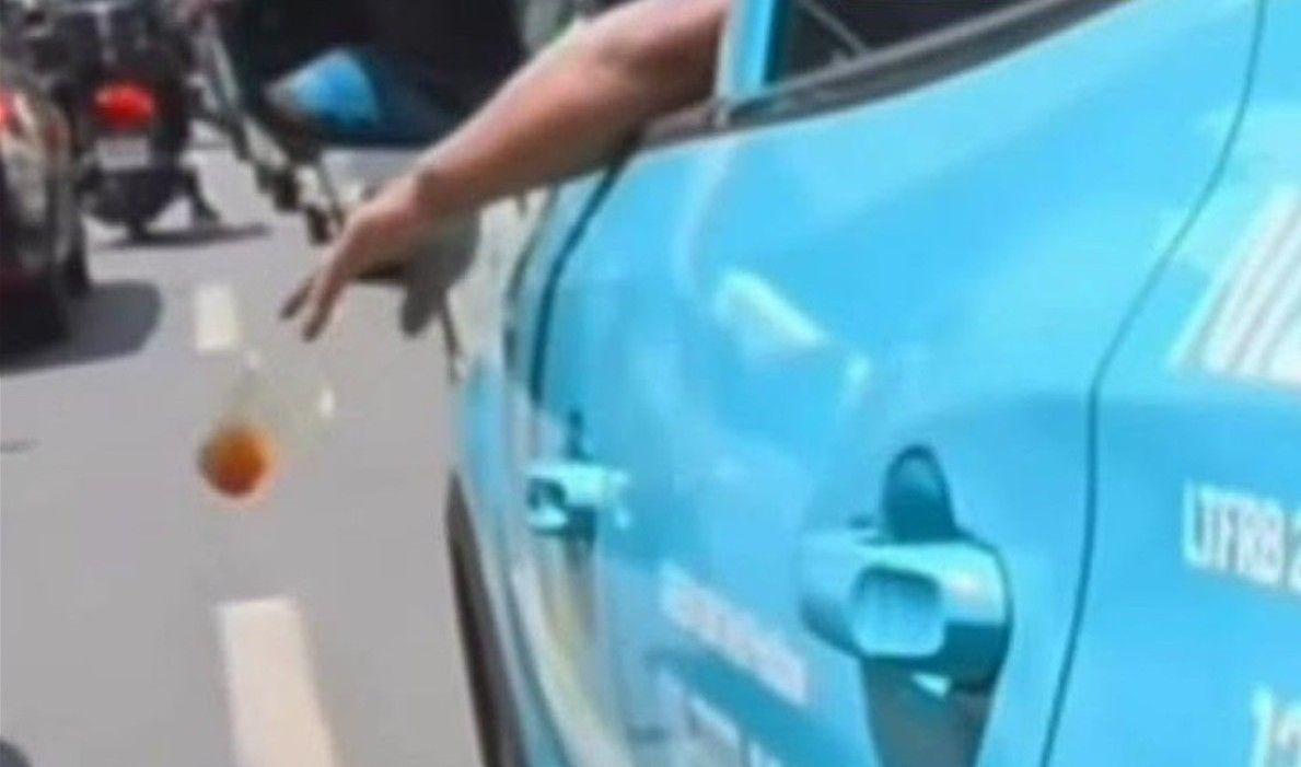 Taxi driver caught throwing trash 