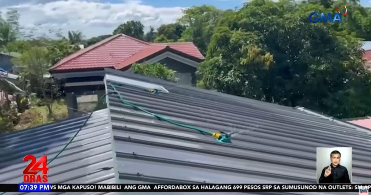 Family in Nueva Ecija installs water sprinkler on roof ahead of super El Niño